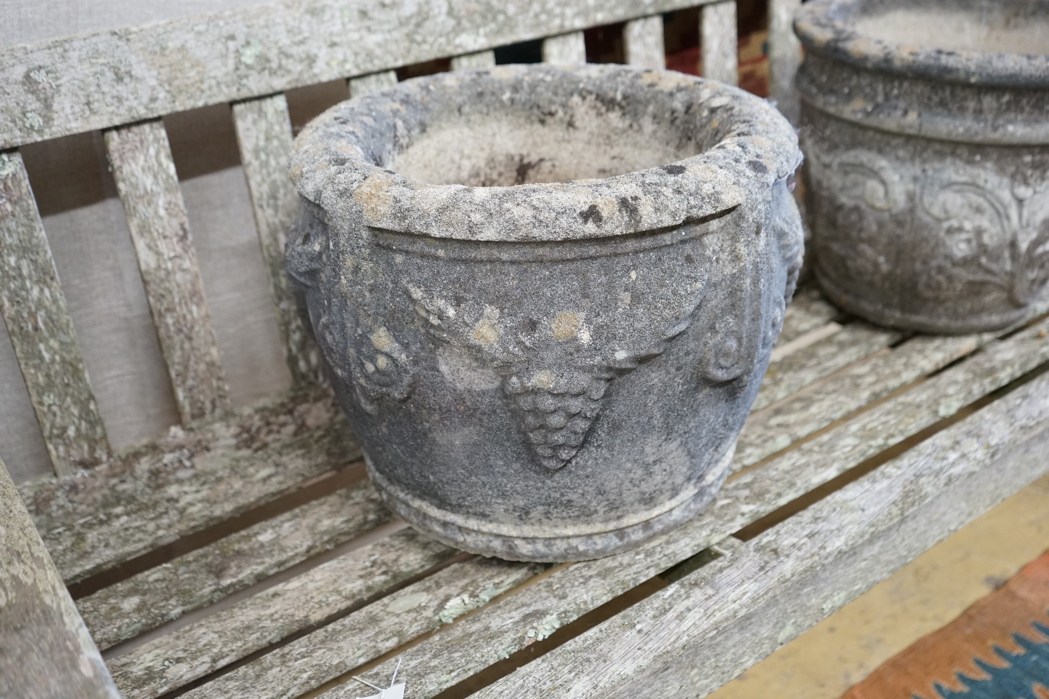 Three circular reconstituted stone garden planters, largest diameter 40cm, height 32cm